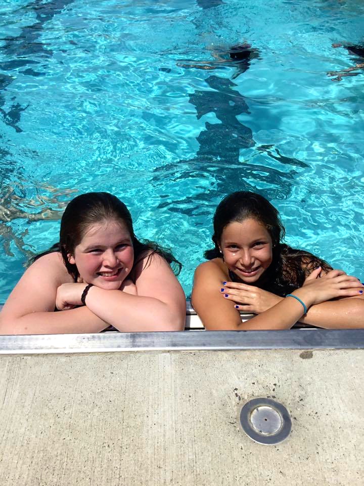Smiling girls in pool