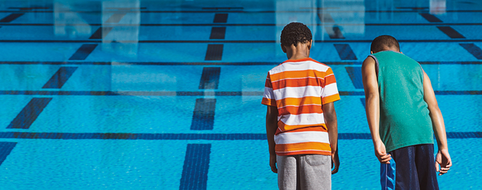 2 boys standing near pool
