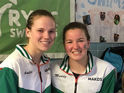 two girls smiling from swim team