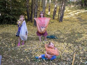 Kids playing outside with the fall leaves