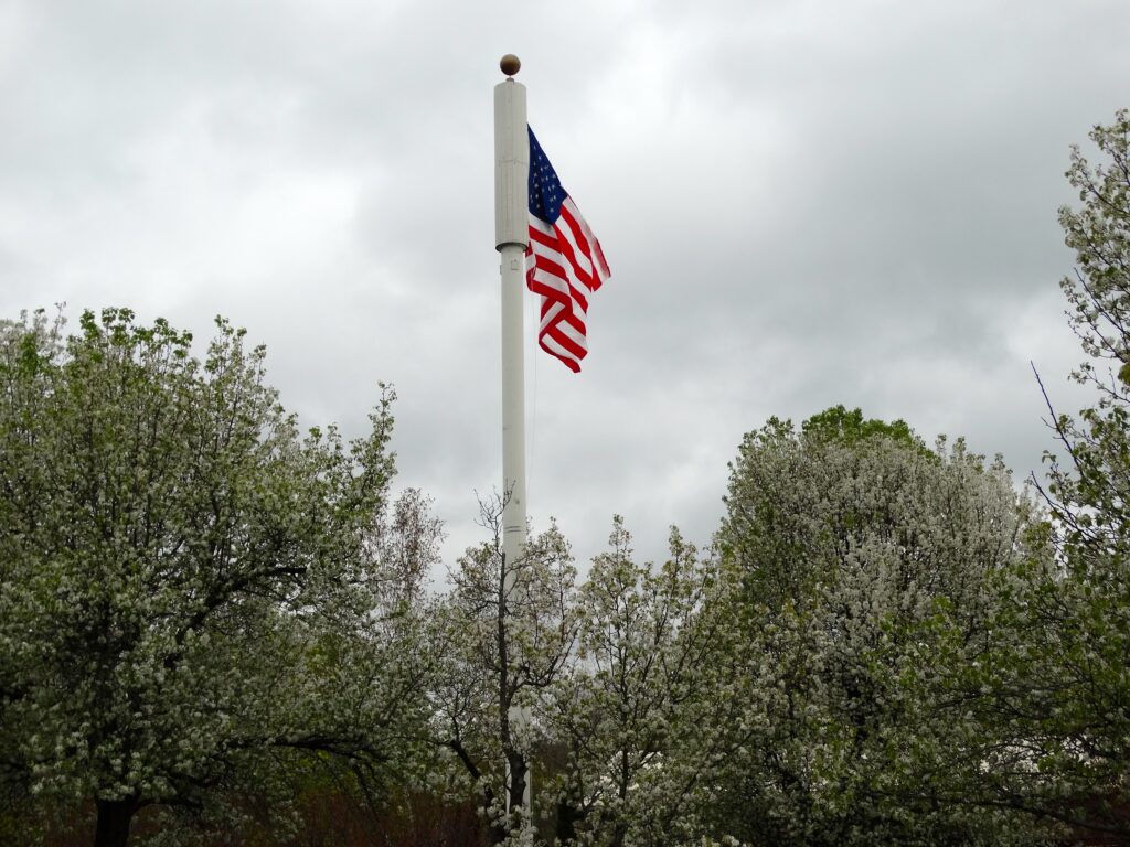 American Flag in front of the YMCAon a cloudy day