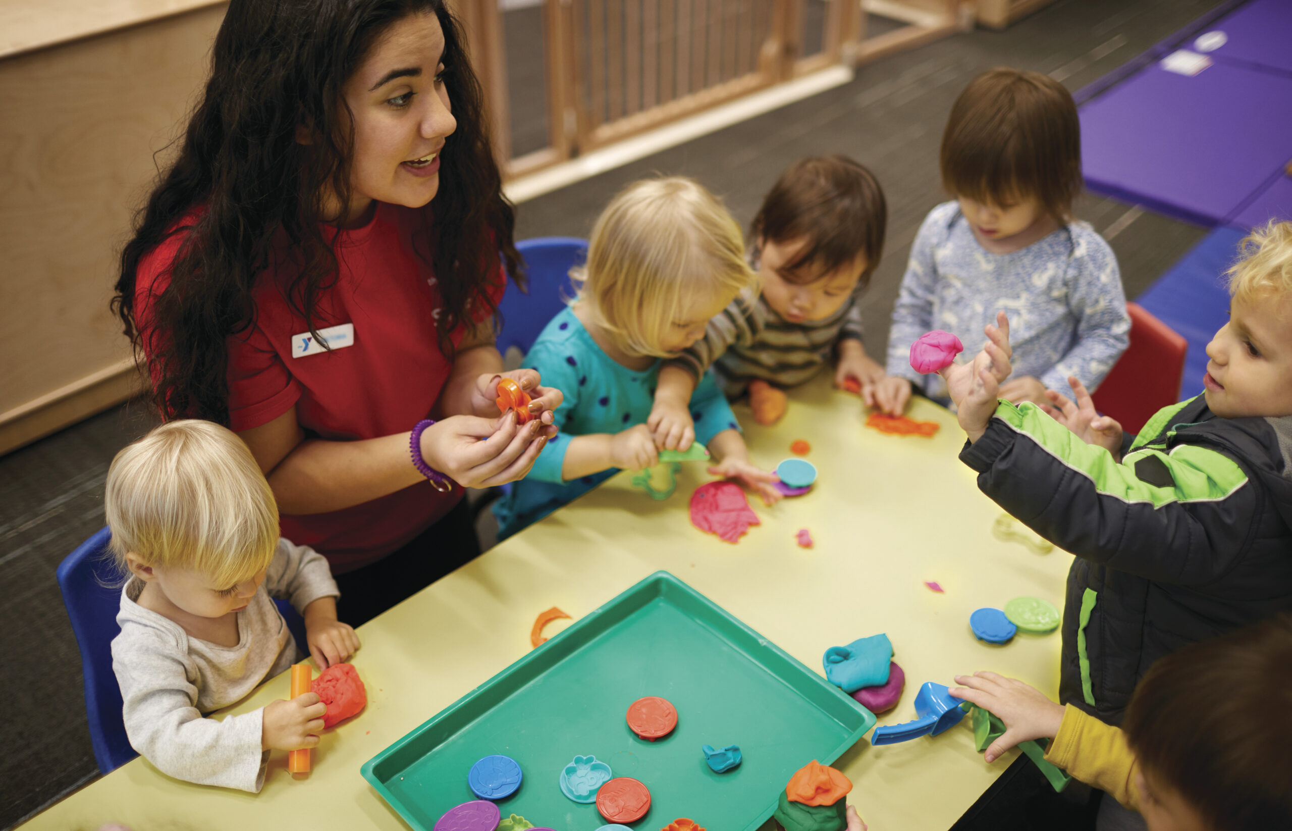 toddlers and instructor with play dough