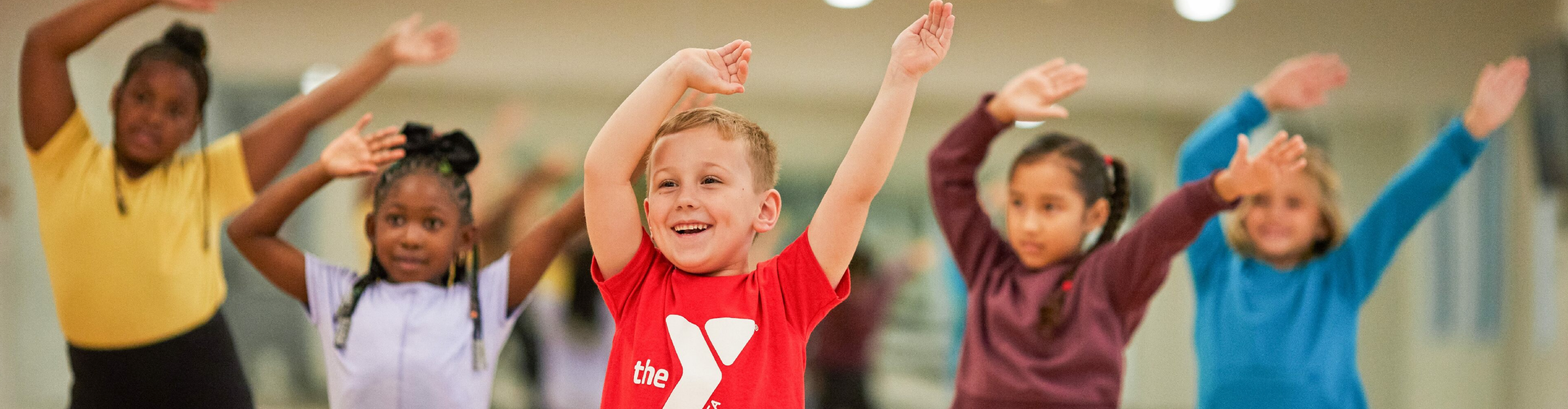 Children waving arms and exercising at the Regional YMCA of Western CT